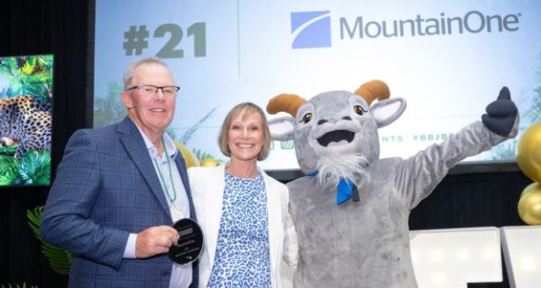 MountainOne President and CEO Robert Fraser and MountainOne Spokesgoat Mo accept a 2025 Best Places to Work award from Carolyn Jones, President and Publisher of the Boston Business Journal