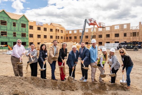 Housing Assistance VP of Real Estate Development David Quinn (fourth from left), CEO Alisa Magnotta, Board Chair Bill Bogdanovich, and state Sen. Julian Cyr, and other guests and officials mark a ceremonial groundbreaking of Cornerstone Hyannis on Friday, May 1 (photo credit: Dellbrook JKS).